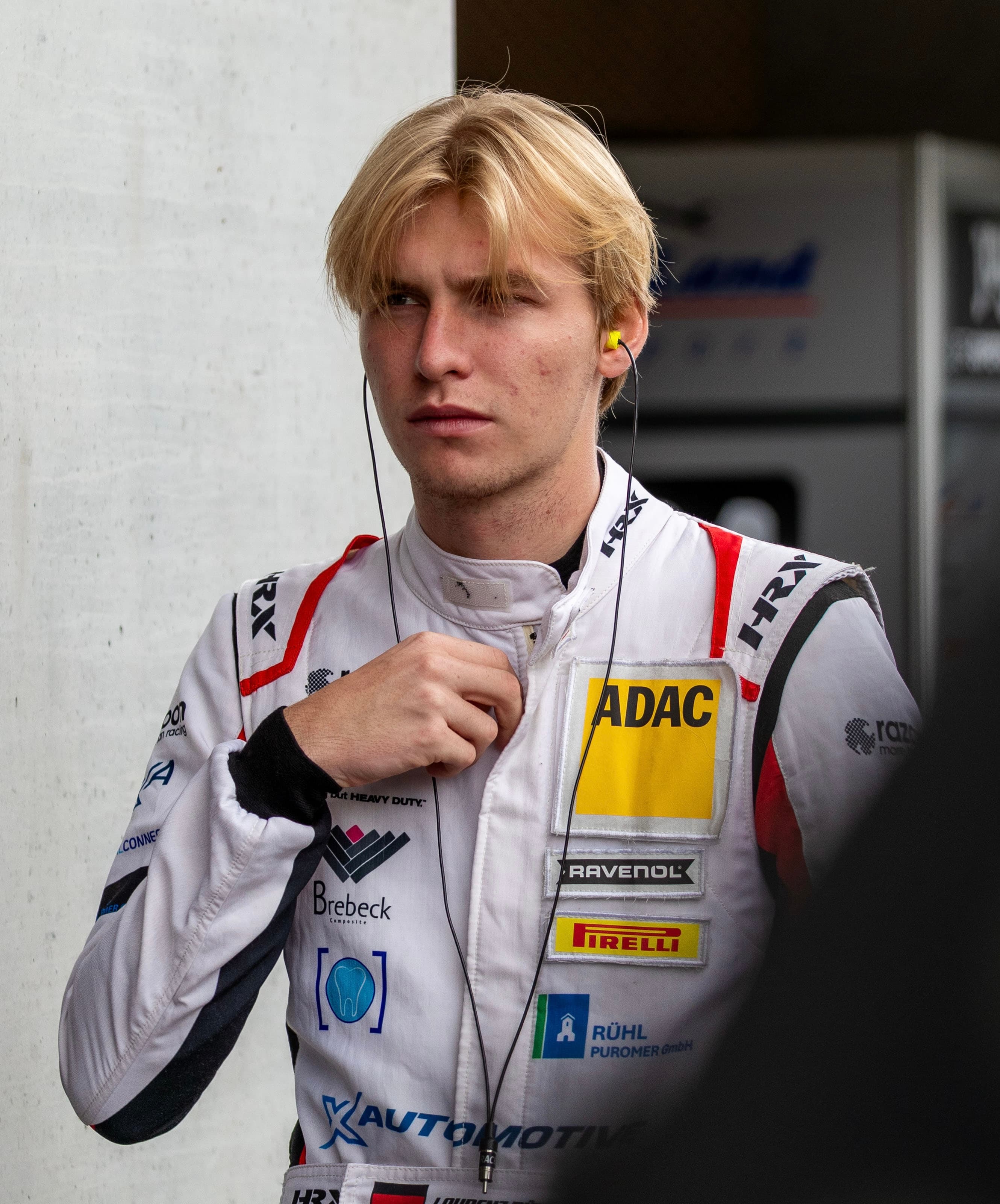 Laurenz Rühl in race suit, zipping up before a session, Red Bull Ring 2025